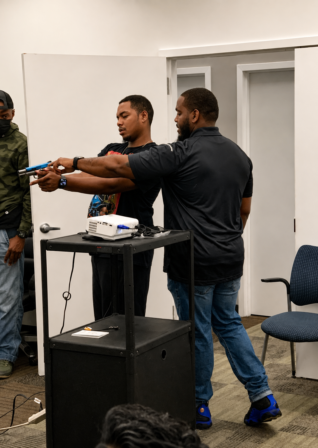 Instructor correcting a student's shooting stance